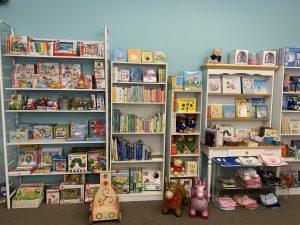 shelves of toys, books, and games, baby stores cape cod 