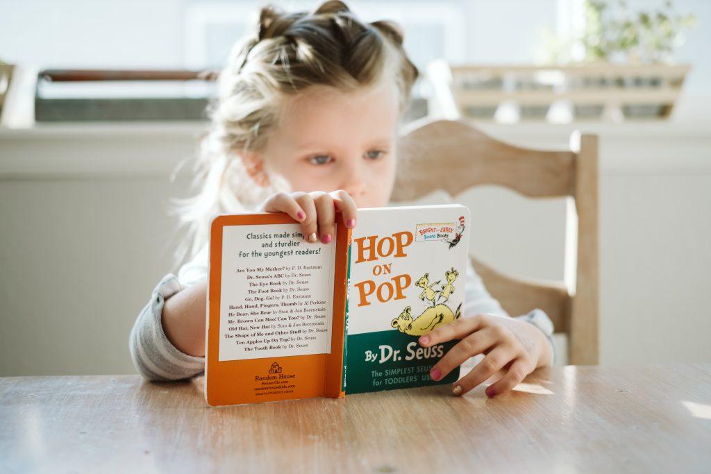 Girl reading Hop on Pop book