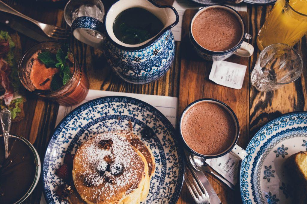 Pancakes and drinks on table, best breakfast spots on the Cape