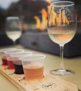 Wine glasses and sample cups by fire, cape cod winery