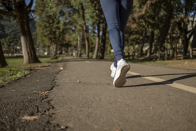 A runner's legs running on pavement, staying safe on the run