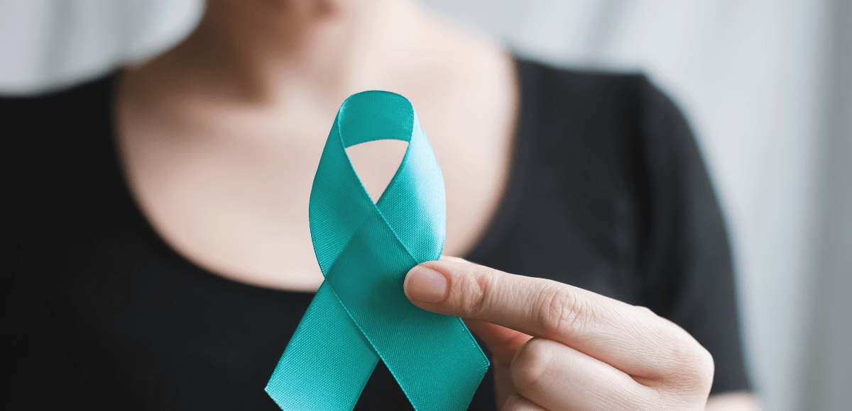 woman holding teal ribbon, navigating aftereffects of sexual assault